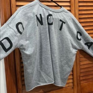 ‘I do not care’ crop top sweater